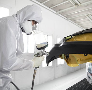 Collision Center Technician Painting a Vehicle | Venice Toyota in Venice FL