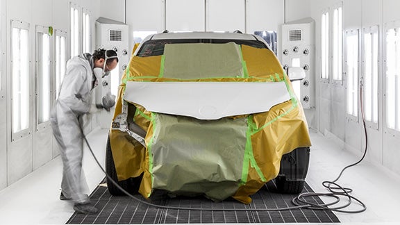 Collision Center Technician Painting a Vehicle | Venice Toyota in Venice FL