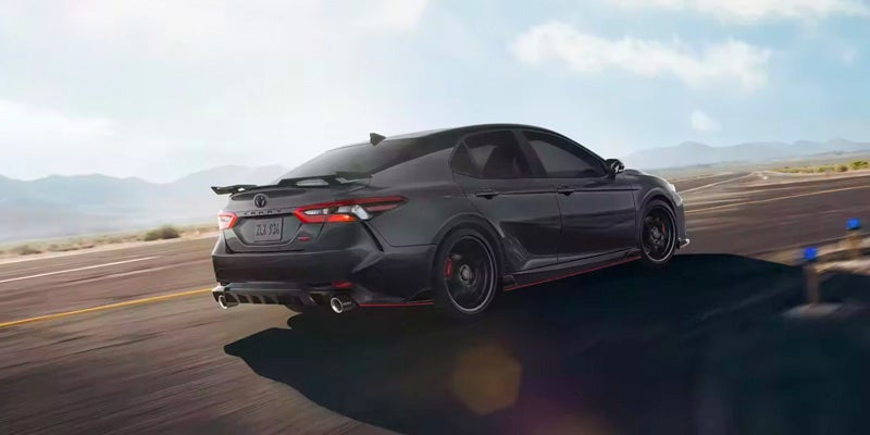 2024 Toyota Camry driving on asphalt